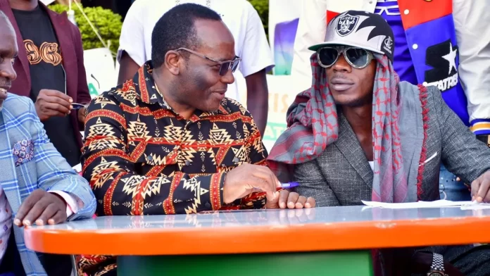 Mathias Mpuuga -Politician (left) and Alien Skin Official -Controversial Performing Artist(Right)